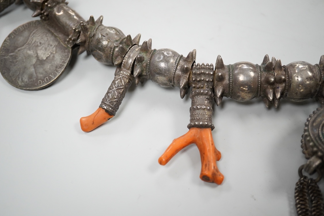A Bedouin white metal and coral mounted necklace, from Oman, 58cm long